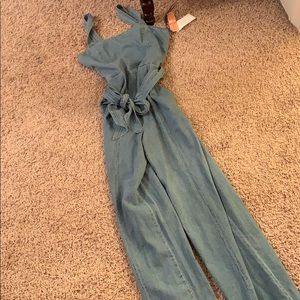 denim overalls w a bow tie in the front